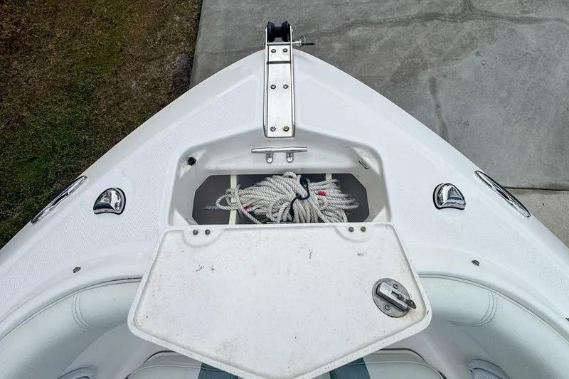Slide: The Image of Bow storage of 2014 Everglades 230 Dual Console boat with rope inside. - 53