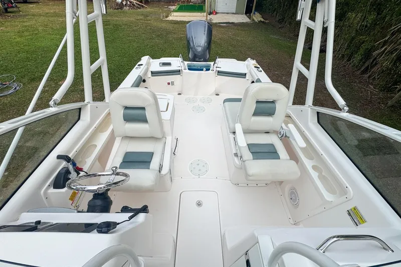 Slide: The Image of 2014 Everglades 230 Dual Console boat interior with seating and steering wheel. - 61