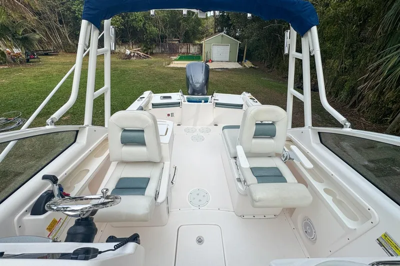 Slide: The Image of 2014 Everglades 230 Dual Console boat interior with seating and steering wheel. - 62