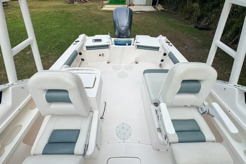Slide: The Image of 2014 Everglades 230 Dual Console boat interior with seating and motor view. - 66