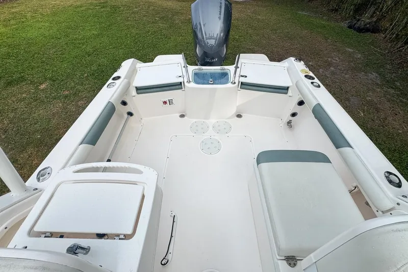 Slide: The Image of 2014 Everglades 230 Dual Console boat interior with seating and storage compartments. - 71