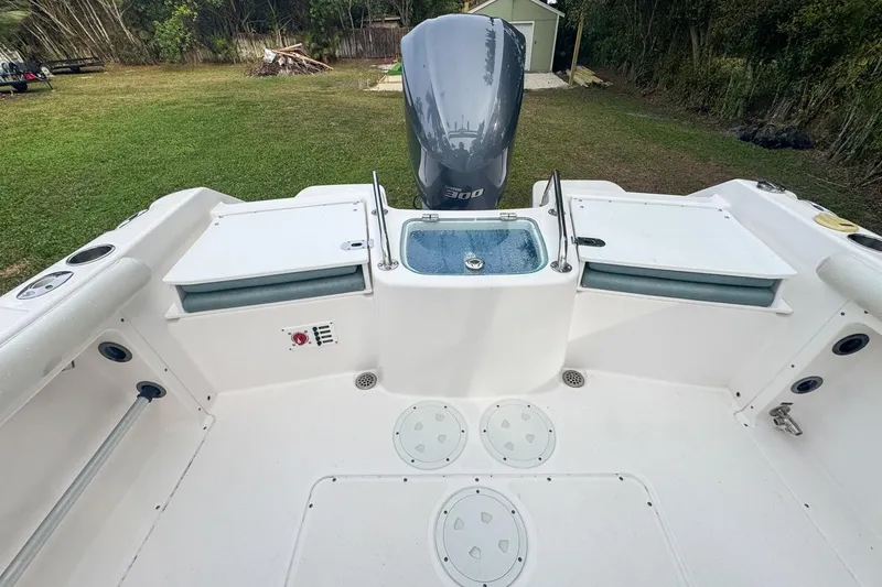Slide: The Image of 2014 Everglades 230 Dual Console boat interior with engine and storage compartments. - 72