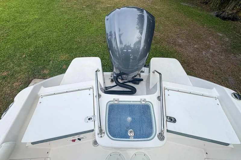 Slide: The Image of 2014 Everglades 230 Dual Console boat with outboard motor and storage compartments. - 73