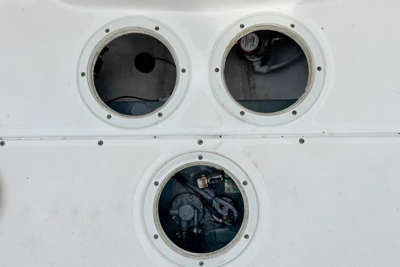 Slide: The Image of Three open hatches on a 2014 Everglades 230 Dual Console boat deck. - 82