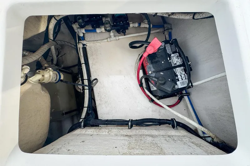 Slide: The Image of 2014 Everglades 230 Dual Console boat battery compartment with wiring and components. - 87