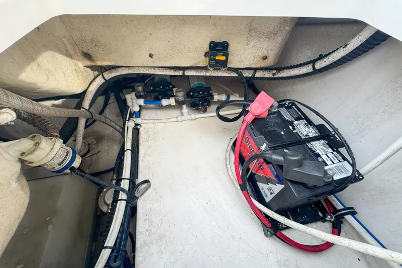 Slide: The Image of 2014 Everglades 230 Dual Console boat battery and wiring compartment. - 88