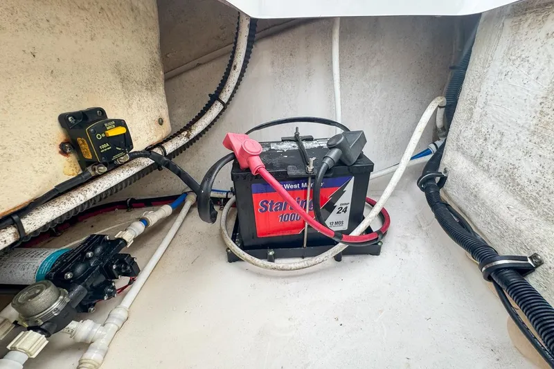 Slide: The Image of Battery compartment of 2014 Everglades 230 Dual Console boat with wiring and components. - 89