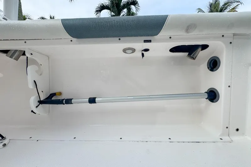 Slide: The Image of 2014 Everglades 230 Dual Console boat storage compartment with rod holder and accessories. - 90