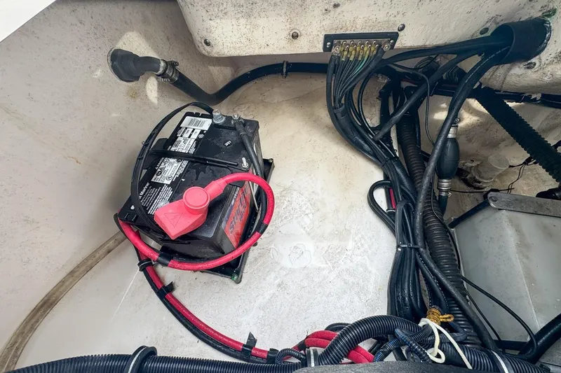 Slide: The Image of 2014 Everglades 230 Dual Console boat interior with seating and steering console. - 91