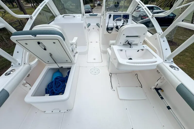 Slide: The Image of 2014 Everglades 230 Dual Console boat interior with storage compartments and seating. - 92