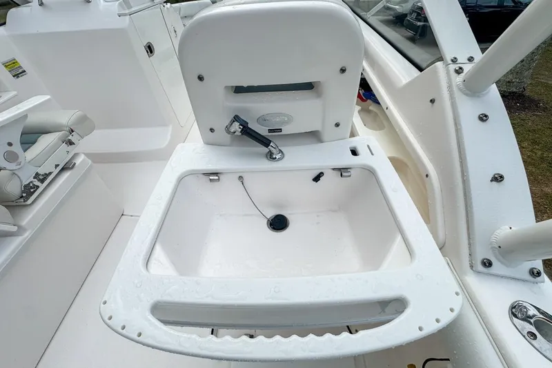 Slide: The Image of 2014 Everglades 230 Dual Console boat interior with open storage compartment. - 98