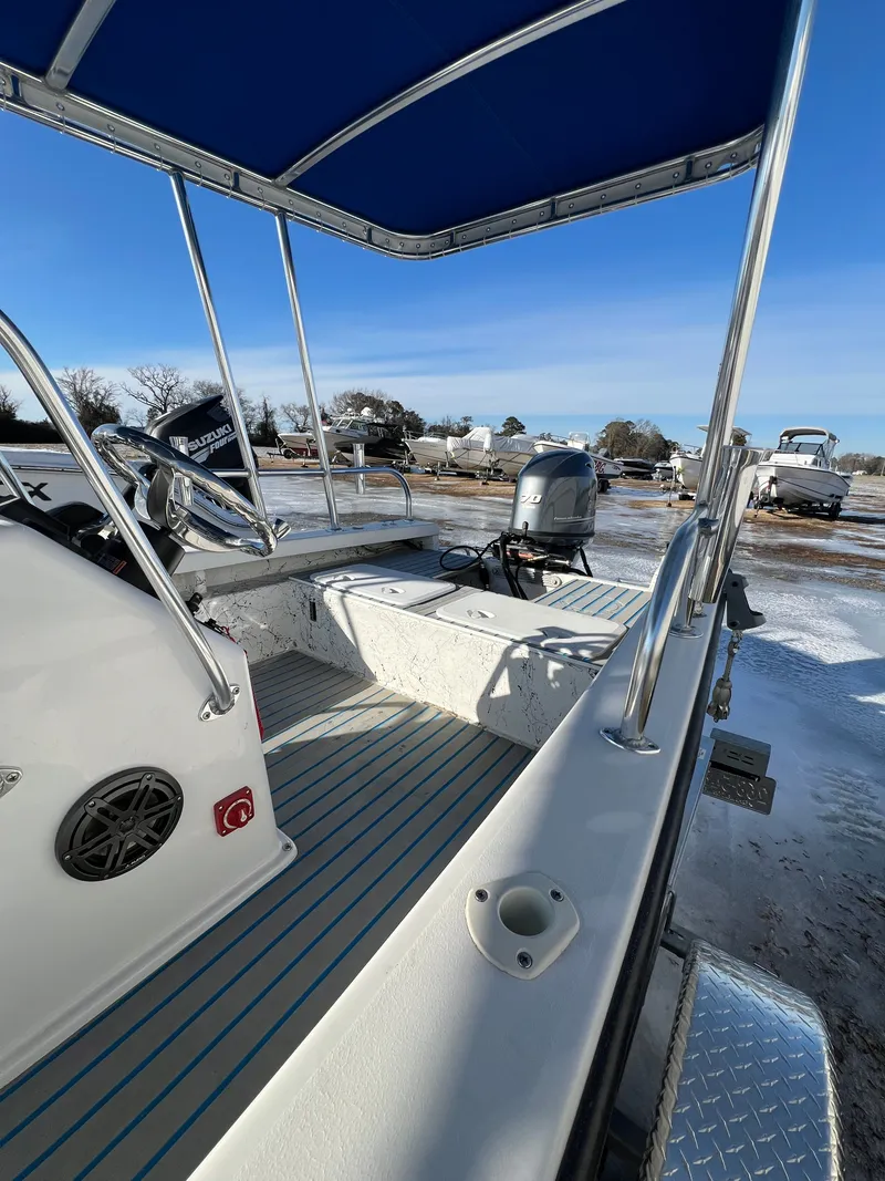 Slide: The Image of 2021 C-Hawk 16 Tiller boat with blue canopy and Suzuki motor. - 12