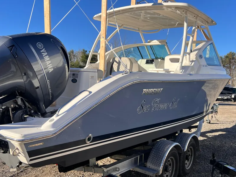 Slide: The Image of 2022 Pursuit DC 266 Dual Console boat on trailer with Yamaha engine. - 14
