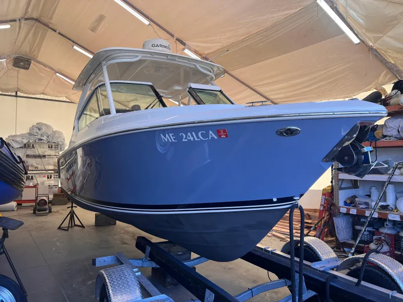 Slide: The Image of 2022 Pursuit DC 266 Dual Console boat on trailer in storage facility. - 17