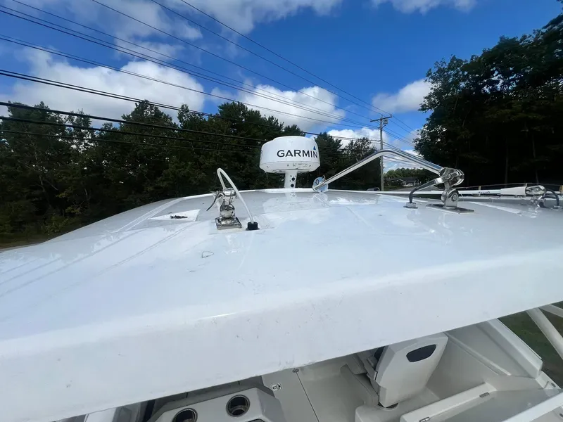 Slide: The Image of 2022 Pursuit DC 266 Dual Console boat with Garmin radar under blue sky. - 33