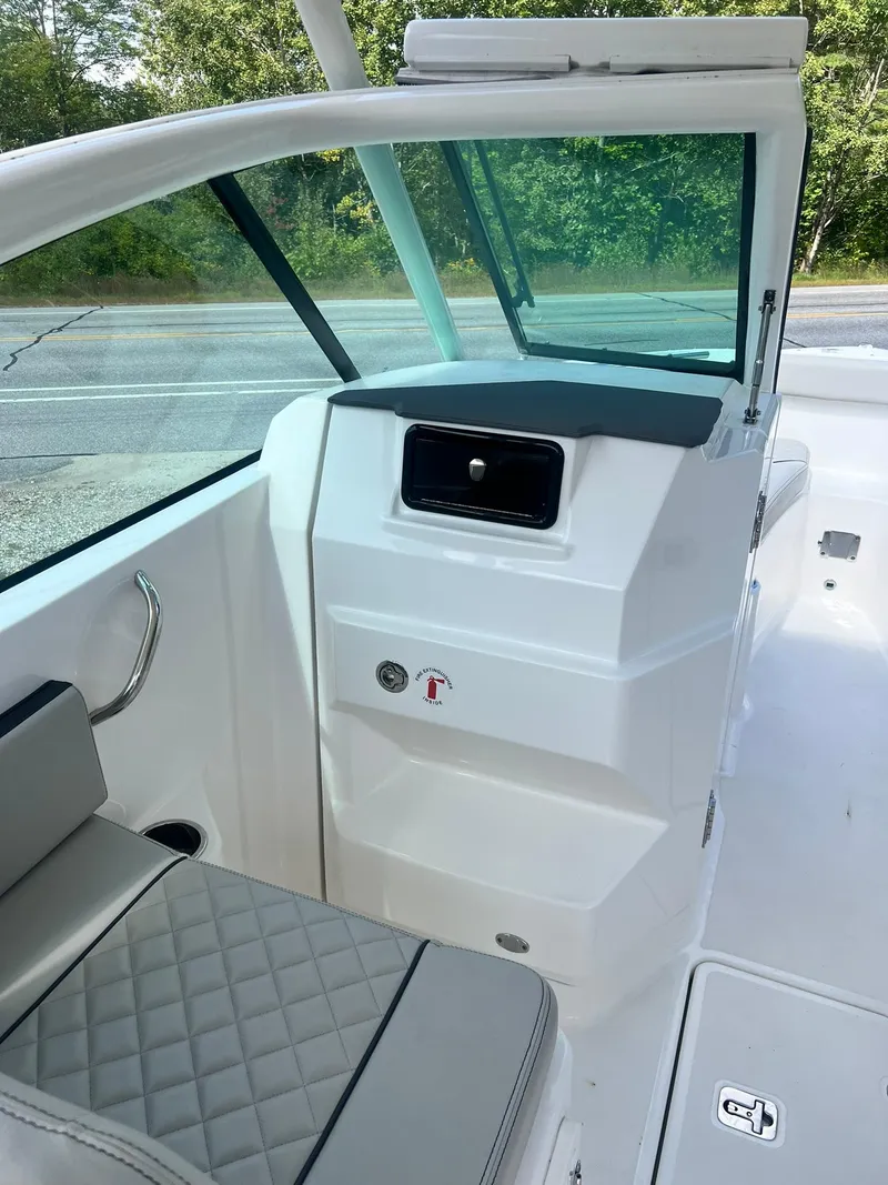 Slide: The Image of 2022 Pursuit DC 266 Dual Console interior with seating and console details. - 40