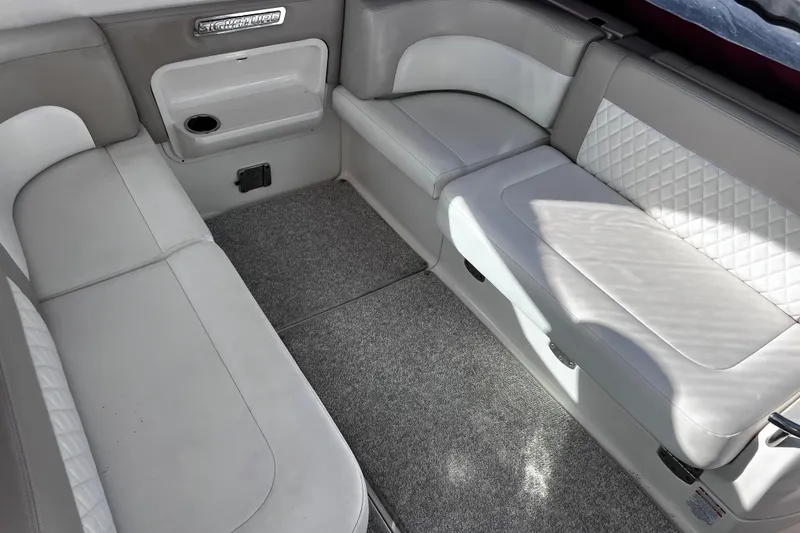 Slide: The Image of 2011 Chaparral 310 Signature boat interior with plush seating and carpeted flooring. - 13