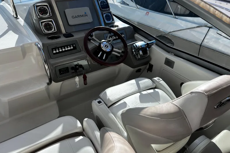 Slide: The Image of 2011 Chaparral 310 Signature boat cockpit with Garmin navigation system and leather seating. - 16