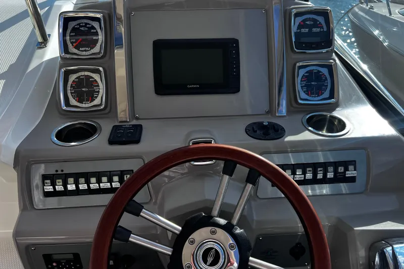 Slide: The Image of 2011 Chaparral 310 Signature boat dashboard with gauges, steering wheel, and controls. - 19