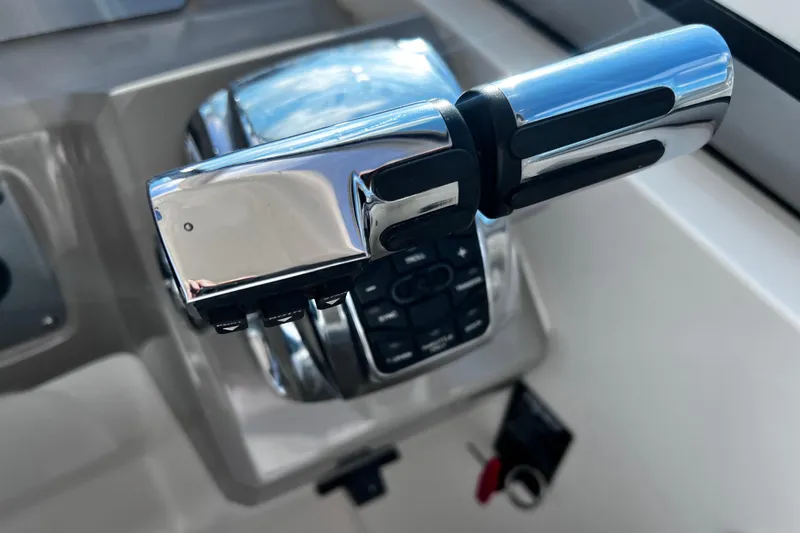 Slide: The Image of Chrome throttle controls on a 2011 Chaparral 310 Signature boat dashboard. - 20