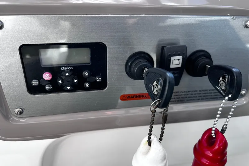 Slide: The Image of Control panel of 2011 Chaparral 310 Signature with keys and Clarion audio system. - 21