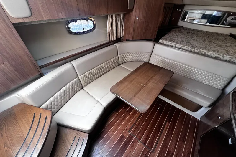 Slide: The Image of Luxurious interior of 2011 Chaparral 310 Signature yacht with elegant seating and wooden table. - 23