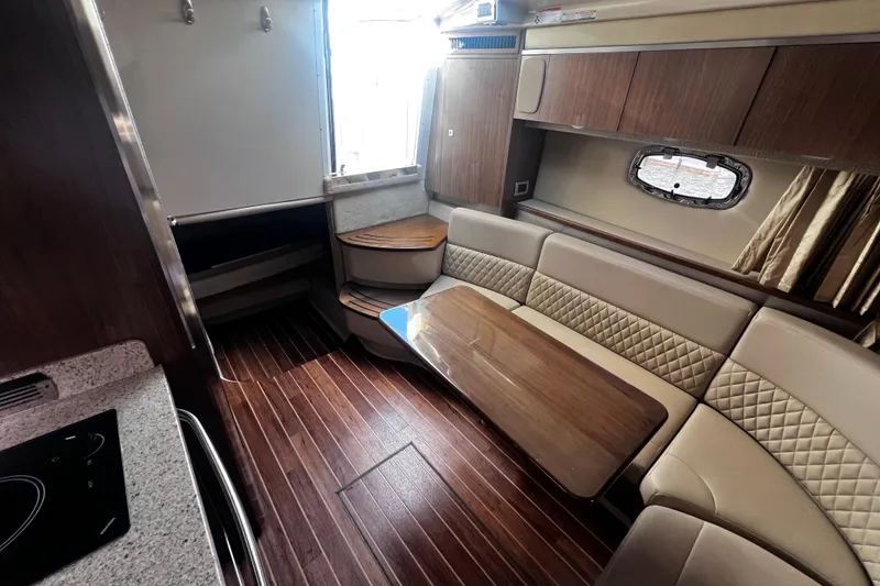 Slide: The Image of Luxurious interior of 2011 Chaparral 310 Signature boat with elegant seating and wood finishes. - 31