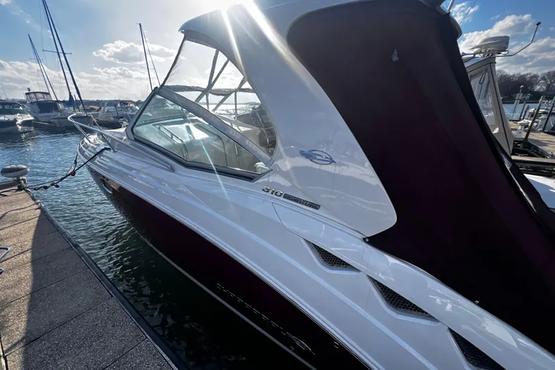 Slide: The Image of 2011 Chaparral 310 Signature boat docked in sunny marina setting. - 33