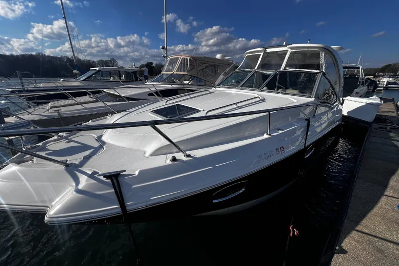 Slide: The Image of 2011 Chaparral 310 Signature boat docked under a clear blue sky. - 34