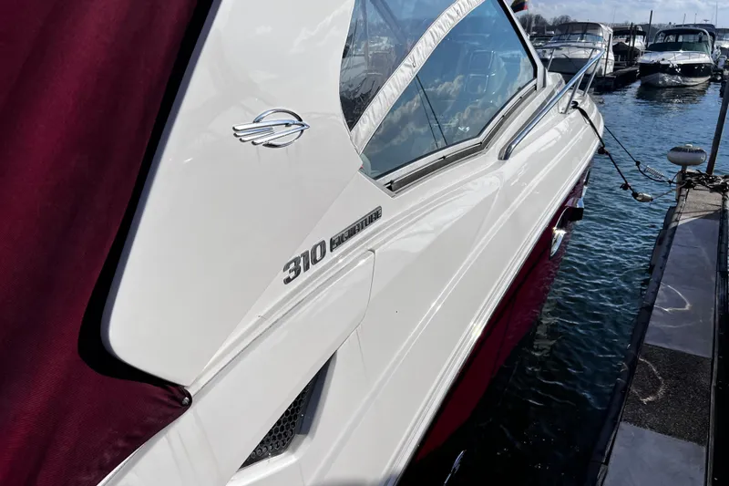 Slide: The Image of 2011 Chaparral 310 Signature boat docked at marina, side view. - 37