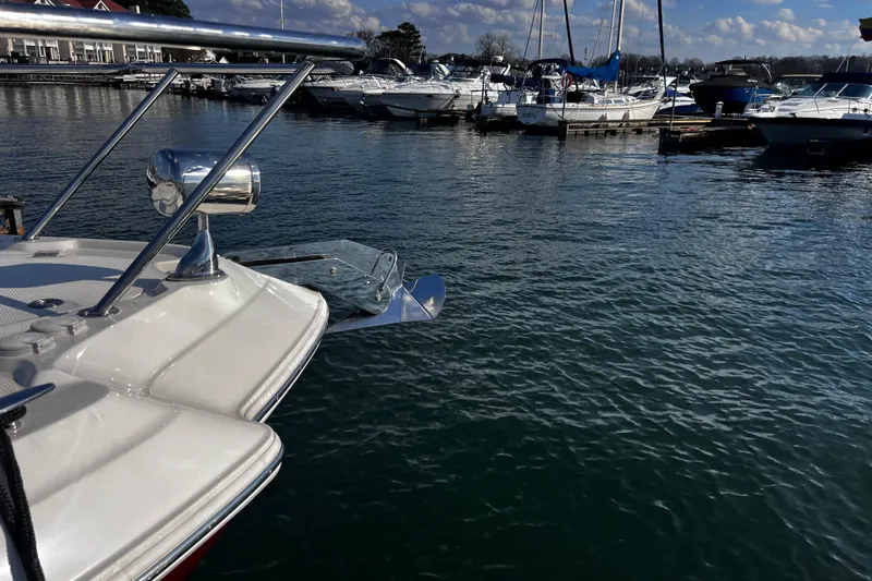 Slide: The Image of Chaparral 310 Signature 2011 boat docked in a marina with other vessels. - 38