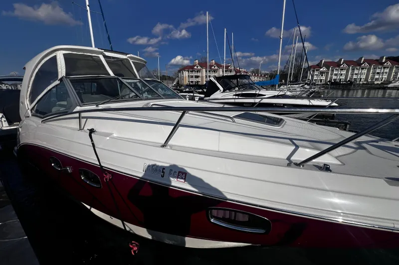 Slide: The Image of 2011 Chaparral 310 Signature boat docked at marina under blue sky. - 39