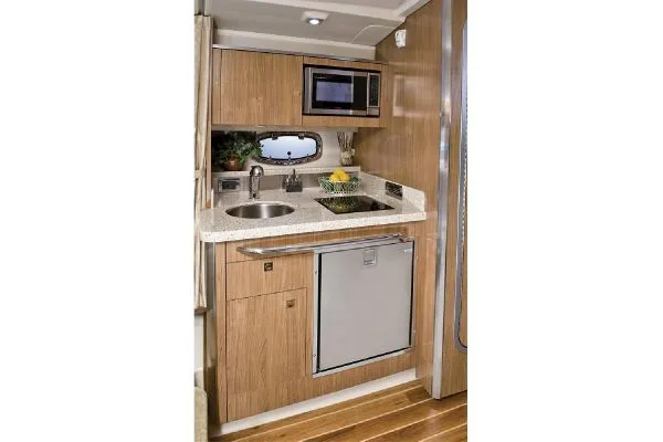 Slide: The Image of Manufacturer Provided Image: Luxurious cabin interior of 2011 Chaparral 310 Signature with cozy bed and elegant decor. - 7