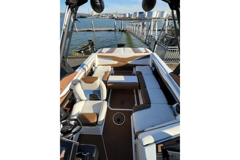 Slide: The Image of 2024 Axis T220 boat interior with spacious seating, docked by the water. - 13