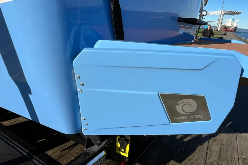 Slide: The Image of 2024 Axis T220 boat with Surf Gate technology, docked by the water. - 17