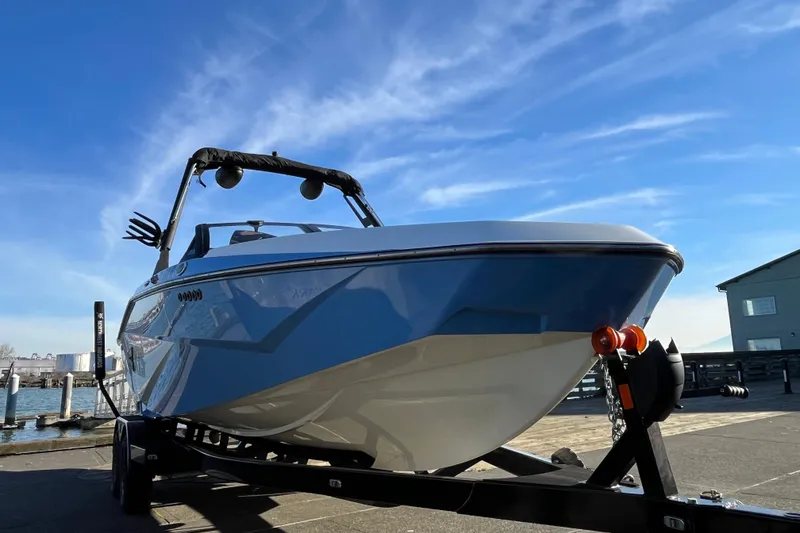 Slide: The Image of 2024 Axis T220 boat on trailer under clear blue sky. - 6