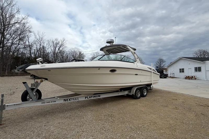 The Image of 2012 Sea Ray 300 SLX boat on trailer, cloudy sky. - 1