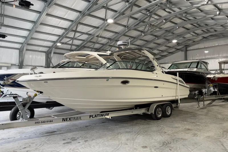 Slide: The Image of 2012 Sea Ray 300 SLX boat in warehouse on trailer. - 11