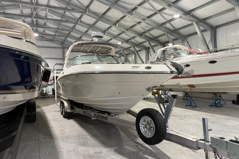 Slide: The Image of 2012 Sea Ray 300 SLX boat in storage facility. - 12