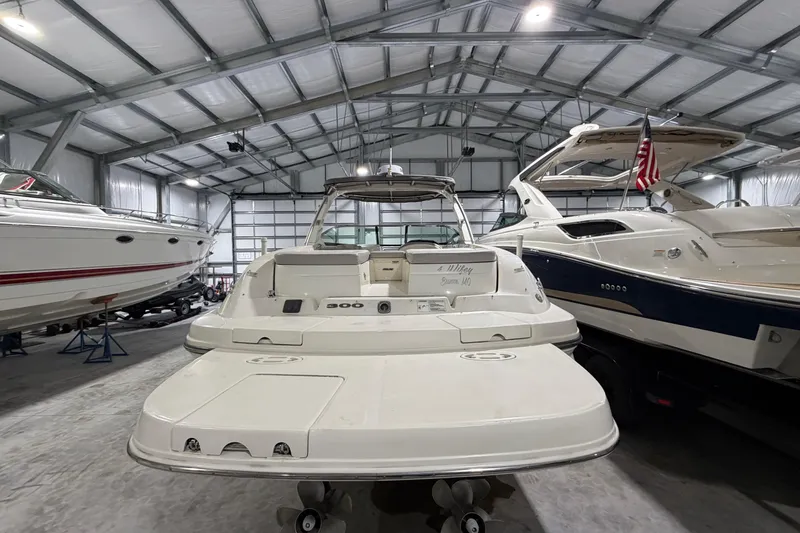 Slide: The Image of 2012 Sea Ray 300 SLX in a boat storage facility. - 13