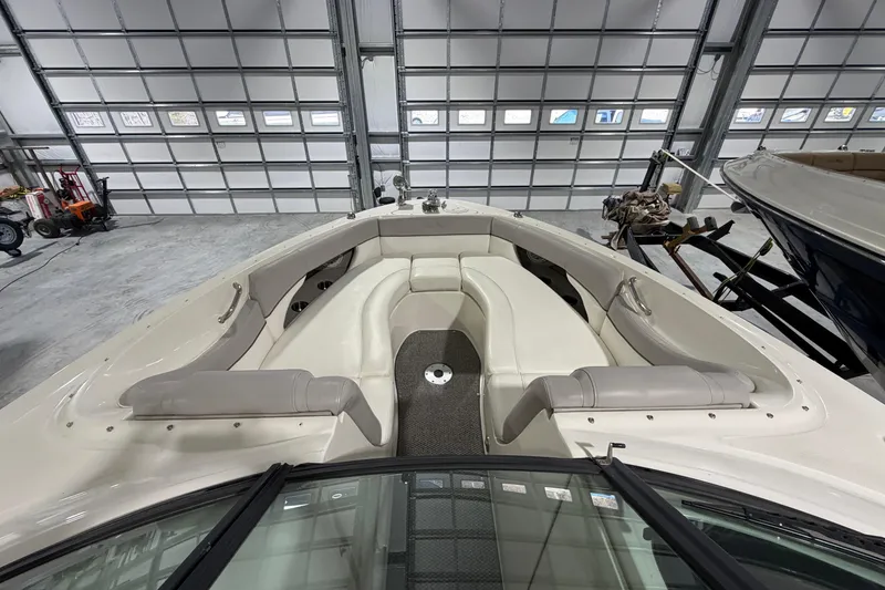 Slide: The Image of 2012 Sea Ray 300 SLX boat interior with white seating in a garage setting. - 16