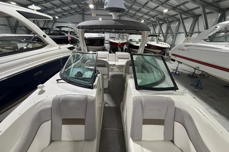 Slide: The Image of 2012 Sea Ray 300 SLX boat in storage, surrounded by other boats. - 18