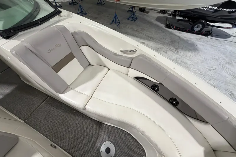 Slide: The Image of 2012 Sea Ray 300 SLX boat interior with beige seating and cup holders. - 19