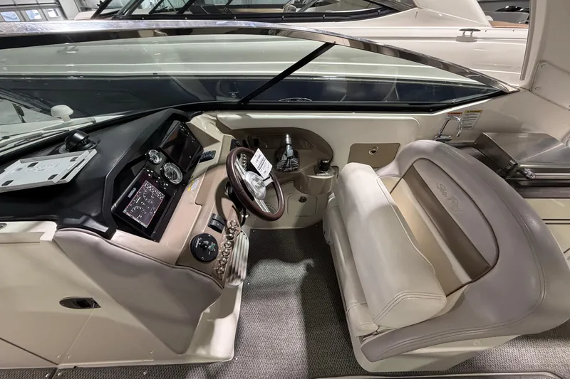 Slide: The Image of 2012 Sea Ray 300 SLX boat interior with steering wheel and dashboard controls. - 22
