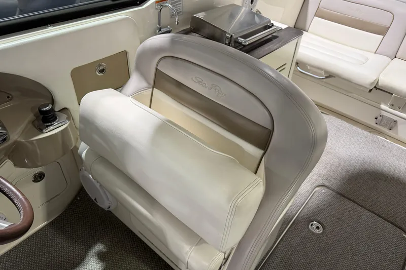 Slide: The Image of Interior of a 2012 Sea Ray 300 SLX boat with beige seating and helm. - 24