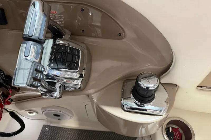 Slide: The Image of Control panel of a 2012 Sea Ray 300 SLX boat with throttle and joystick. - 25