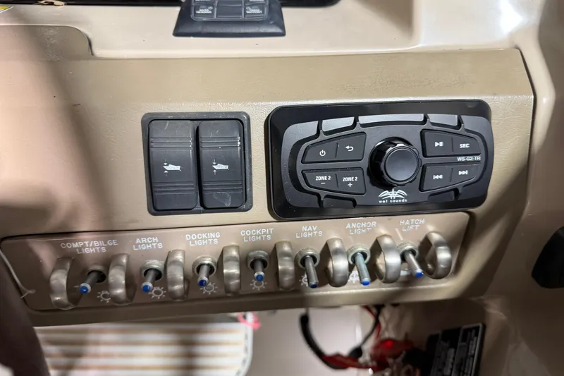 Slide: The Image of Control panel of a 2012 Sea Ray 300 SLX boat with various switches and audio controls. - 26