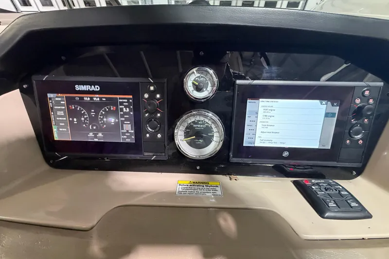 Slide: The Image of 2012 Sea Ray 300 SLX dashboard with Simrad displays and gauges. - 28