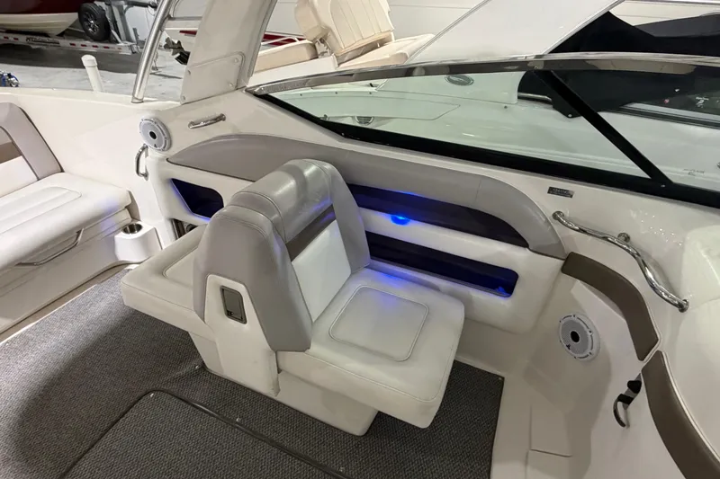 Slide: The Image of Interior of a 2012 Sea Ray 300 SLX boat with white seating and blue accent lighting. - 31