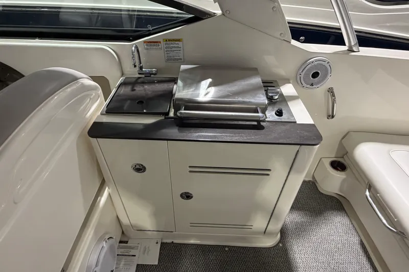 Slide: The Image of 2012 Sea Ray 300 SLX boat interior with kitchenette and sink. - 33